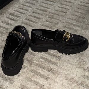 Steve Madden Glossy Black Loafers with Gold Accent